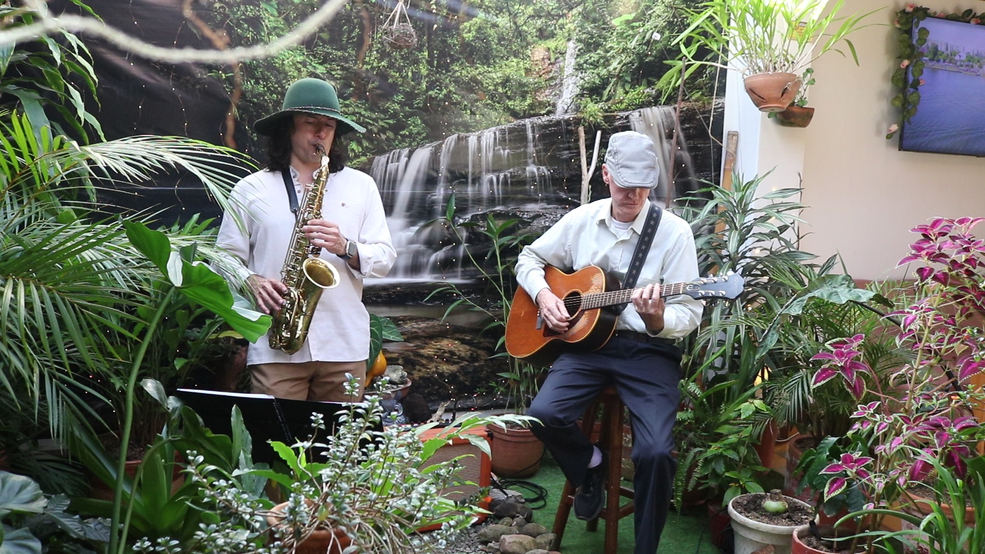 El dúo de Jazz al Patio: saxofonista de pie y guitarrista sentado, tocando en el patio de Biodiverso